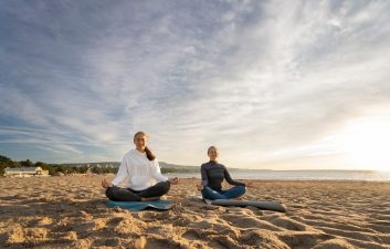 front-view-mother-daughter-doing-yoga_23-2149854597